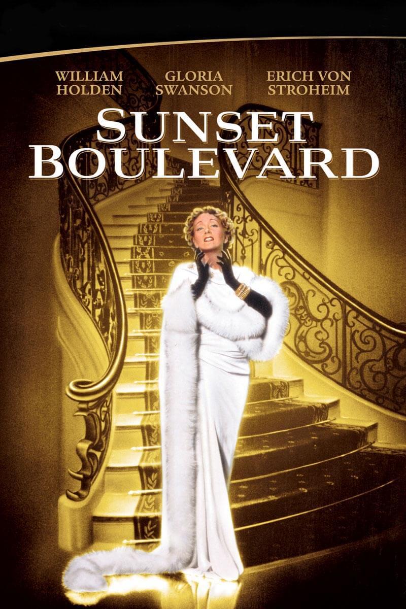 Photo showing cover image of Sunset Boulevard. Woman in white dress standing at bottom of stairs.